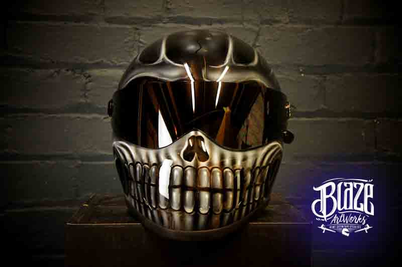 Black motorcycle helmet with detailed white skull design featuring realistic jaw bones and teeth, gothic style airbrush work
